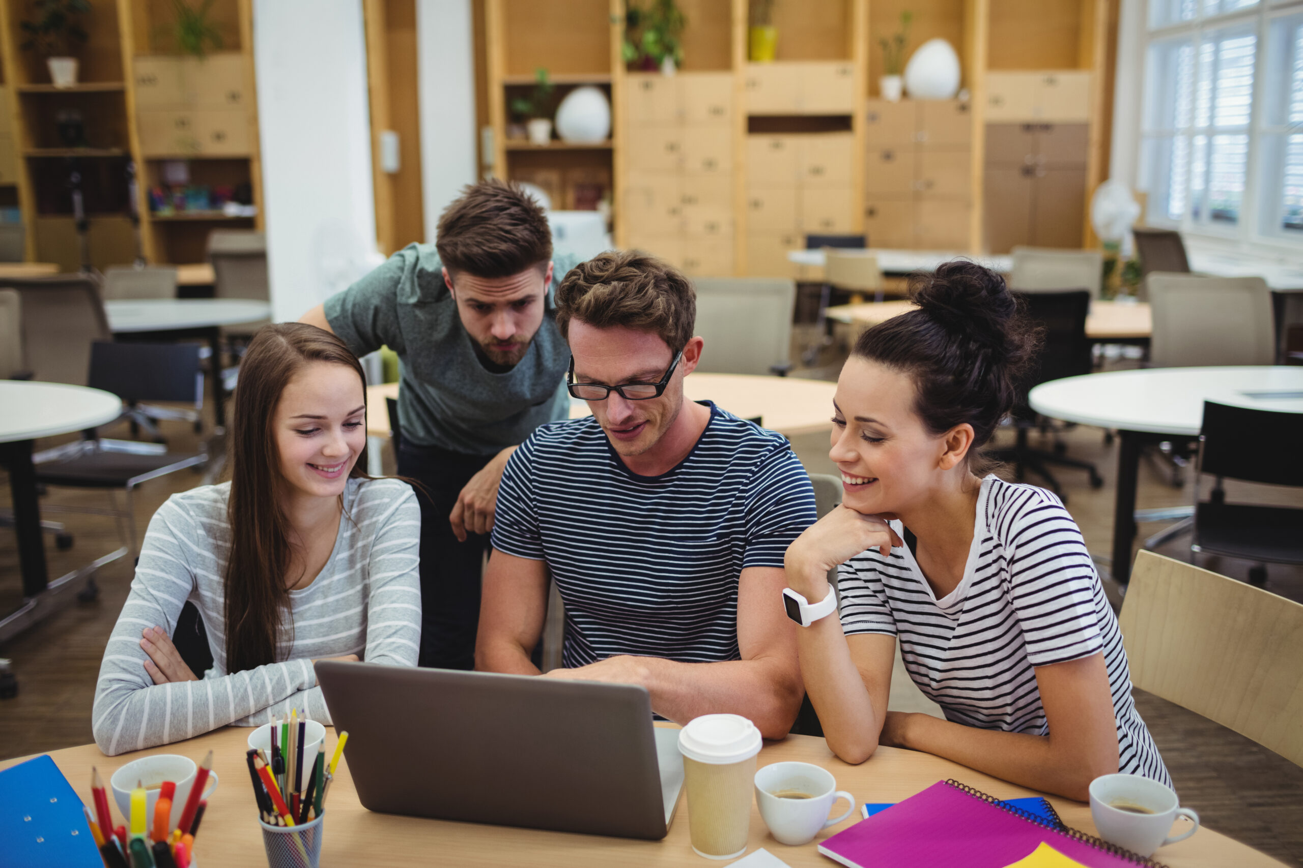 group business executives discussing laptop their des scaled